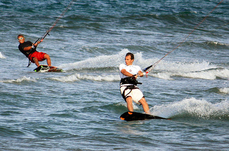 Two guys practicing kitesurf at sunset. Bay of Pollensa